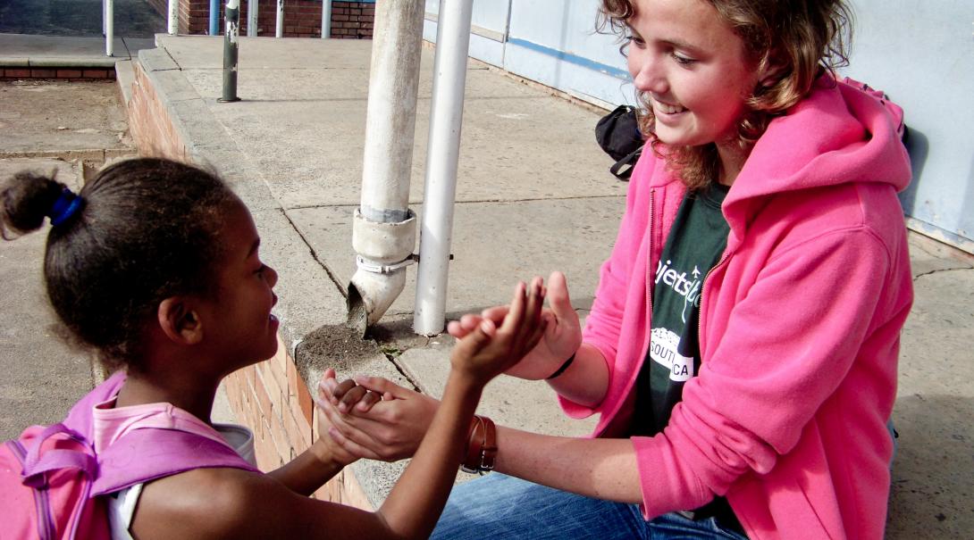 Projects Abroad volunteer works with a South Africa child during her gap year in 2019 Global Gap Year programme volunteer plays a game with a child during her project in South Africa